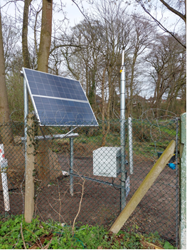 Image of a solar panel with trees in the background on the site of a UK water utility