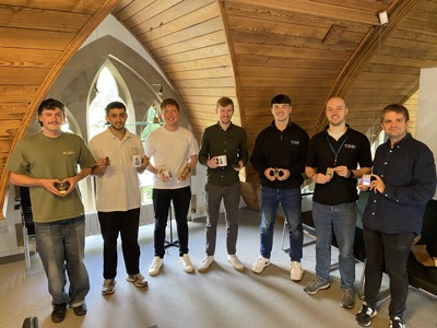 A photo of Atmos colleagues with their football awards